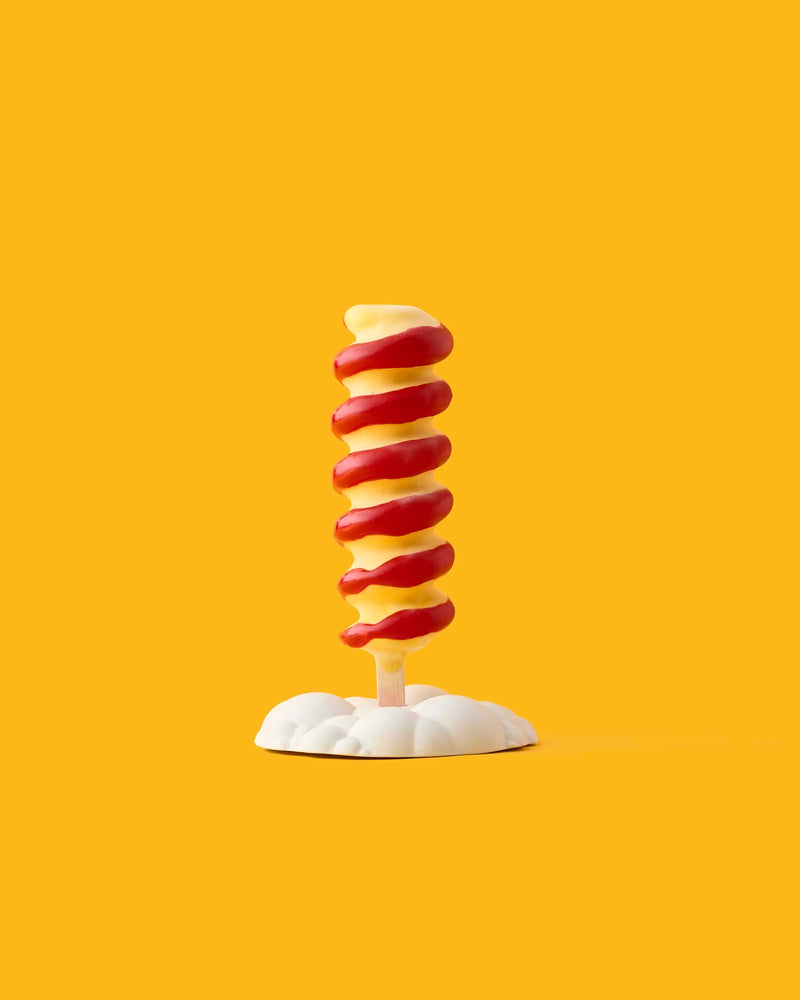 GLO Pasticceria spiral popsicle with alternating red and pale yellow layers on a white cloud-shaped stand against a yellow background